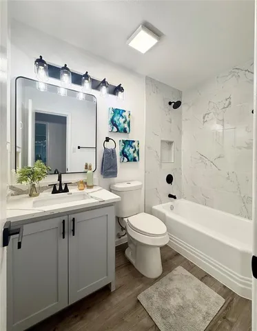 a bathroom with a sink toilet and shower