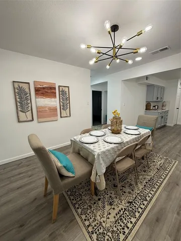 a view of a dining room and livingroom with furniture