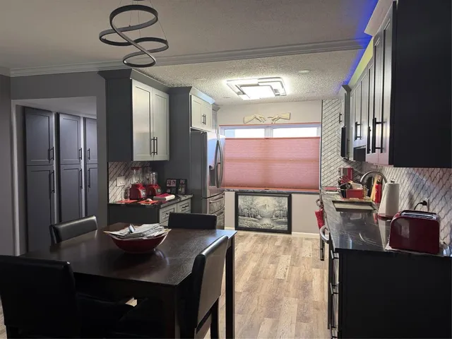 a kitchen with stainless steel appliances kitchen island granite countertop a sink and cabinets