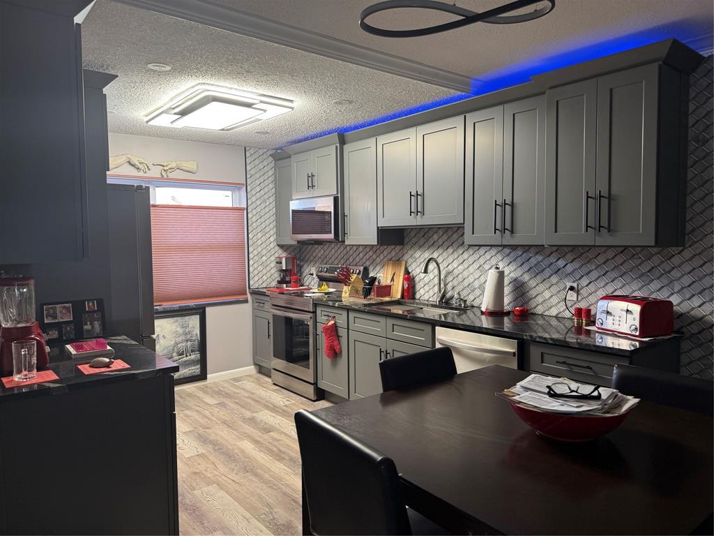 25 Southeast 13th Street Boca Raton, FL 33432 - Photo 2 of 7 a kitchen with sink cabinets and appliances