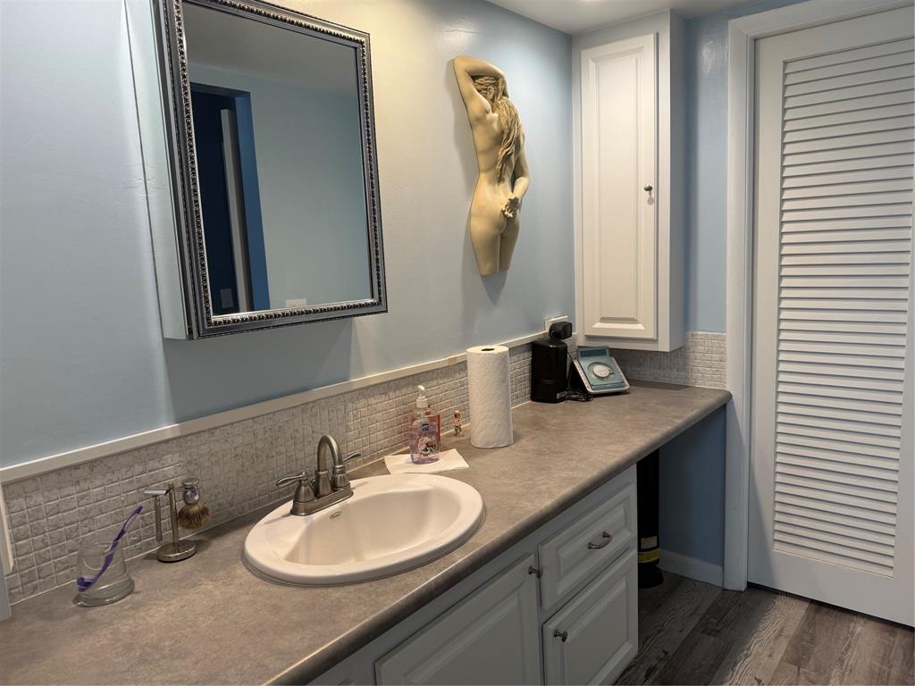 25 Southeast 13th Street Boca Raton, FL 33432 - Photo 5 of 7 a bathroom with a granite countertop sink and a mirror
