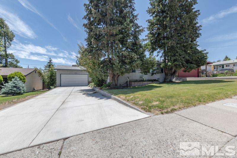 1990 Marlette Avenue Reno, NV 89503 - Photo 1 of 21 a front view of a house with a yard and garage