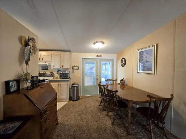 a view of a dining room with furniture and window