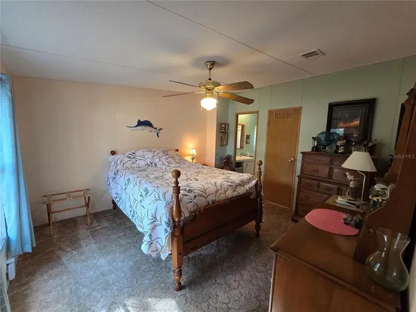 a bedroom with bed and a chandelier
