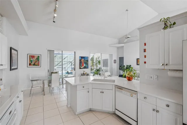 a room with a white cabinets and white appliances