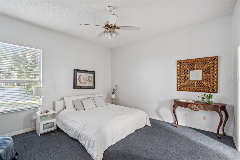 3447 Amaca Circle Orlando, FL 32837 - Photo 16 of 30 a bedroom with a bed and a chandelier
