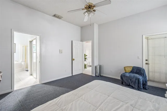 a white bath tub sitting next to a white sink and a mirror