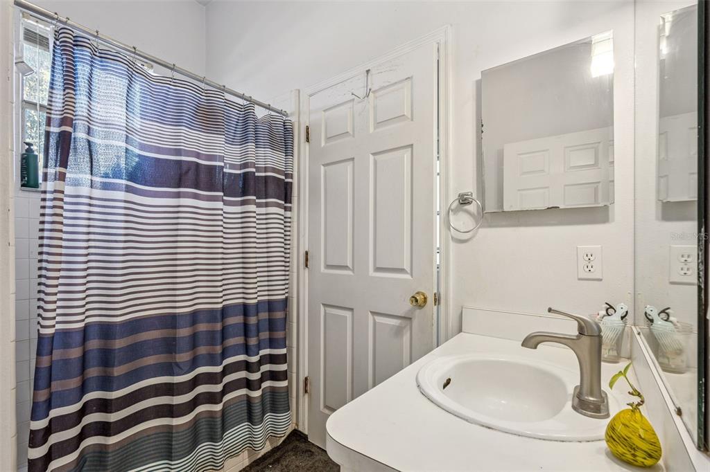 3447 Amaca Circle Orlando, FL 32837 - Photo 22 of 30 a bathroom with a sink and a mirror