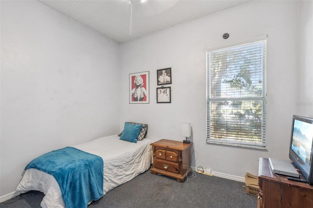 3447 Amaca Circle Orlando, FL 32837 - Photo 24 of 30 a bedroom with a bed and a flat screen tv