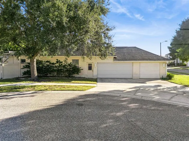 a view of a house with a swimming pool and a yard