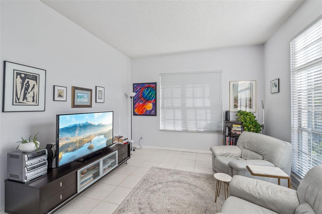 3447 Amaca Circle Orlando, FL 32837 - Photo 6 of 30 a living room with furniture and a flat screen tv