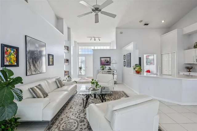a living room with furniture and kitchen view