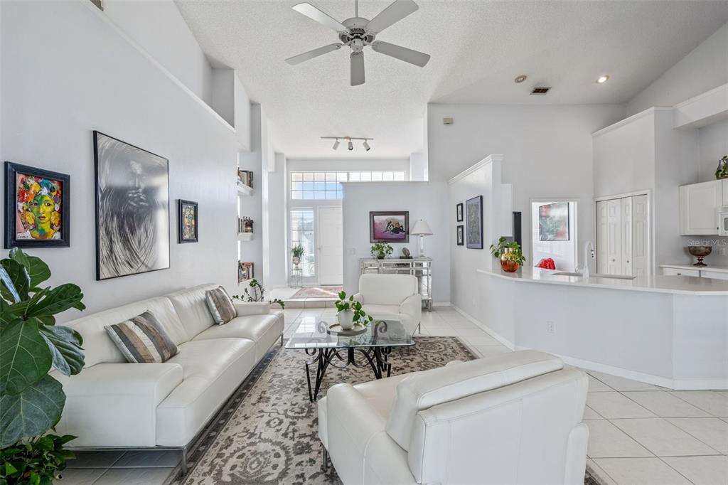 3447 Amaca Circle Orlando, FL 32837 - Photo 7 of 30 a living room with furniture and kitchen view