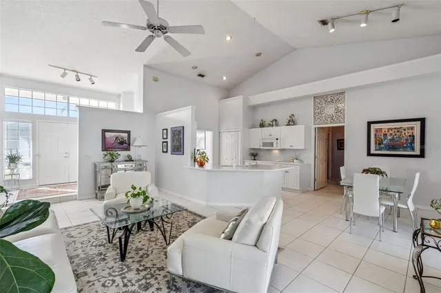 a living room with furniture and kitchen view