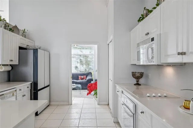 a kitchen with stainless steel appliances kitchen island granite countertop a sink stove and refrigerator