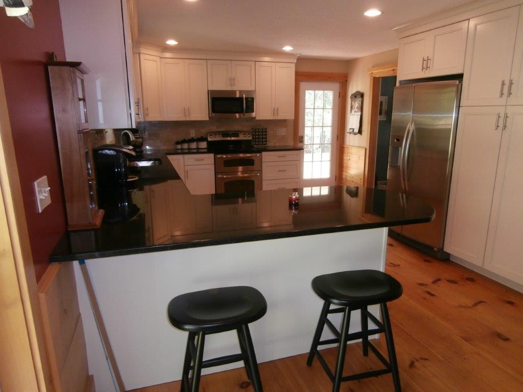 250 Hardwick Road Barre, MA 01005 - Photo 10 of 30 a kitchen with stainless steel appliances kitchen island granite countertop a refrigerator a stove a sink and a microwave