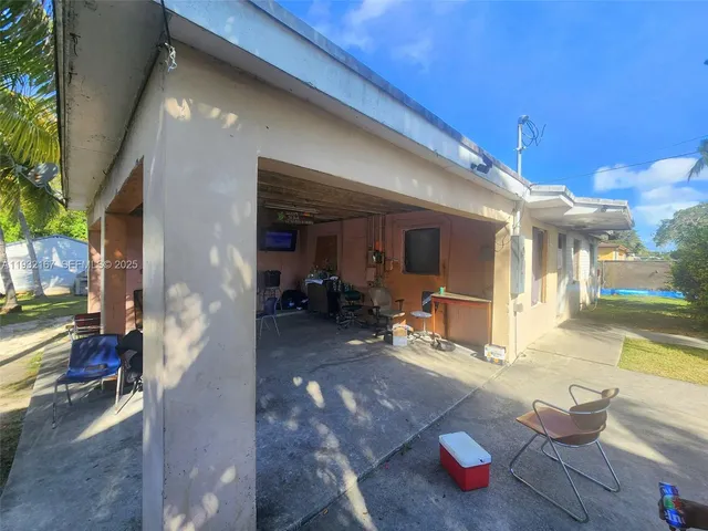 a view of a porch with dining table and chairs
