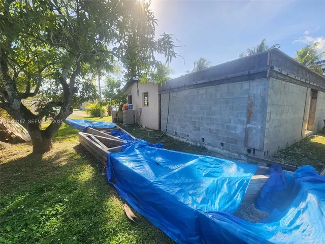 a backyard of a house with table and chairs