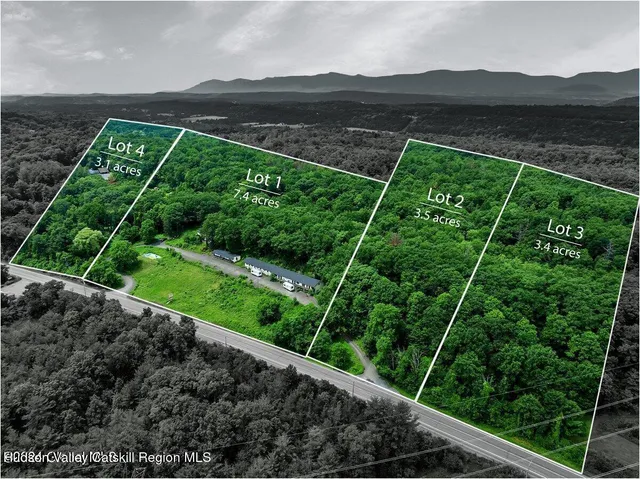 a view of a yard with wooden fence