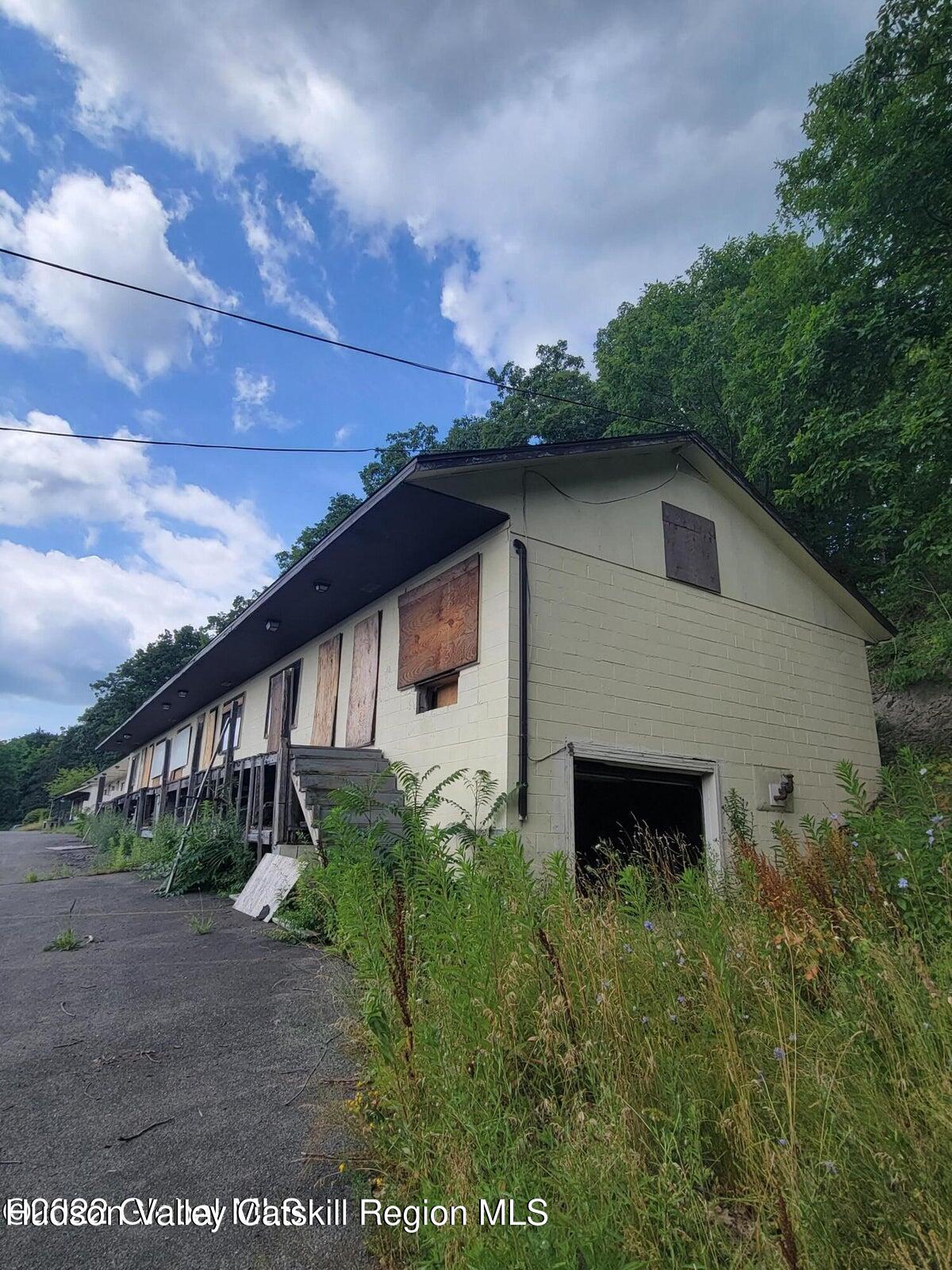 9071 Rte 9W Athens, NY 12015 - Photo 19 of 26 a backyard of a house with plants and large tree