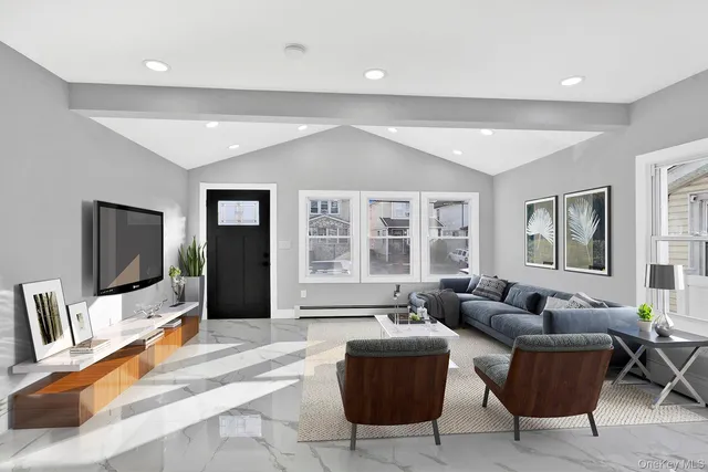 a living room with furniture and a flat screen tv