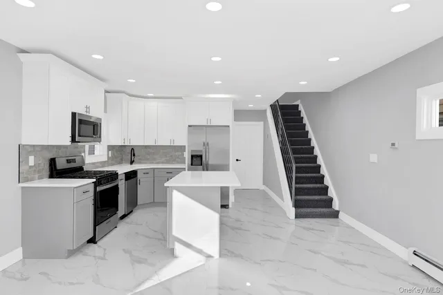 a kitchen with a sink stainless steel appliances and cabinets