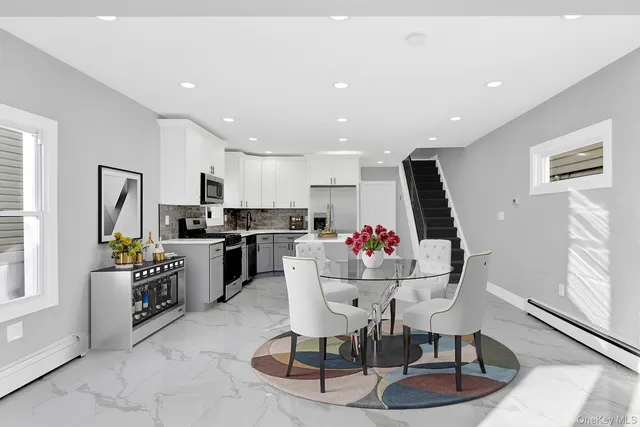 a living room with furniture and kitchen view