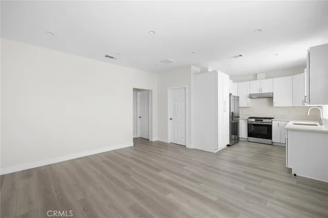 a view of a kitchen with wooden floor