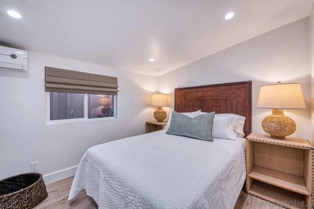 a bedroom with a bed and window