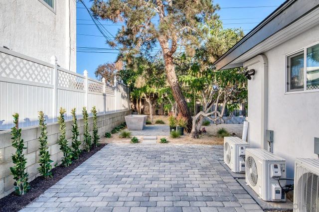 a view of a patio with table and chairs and potted plants