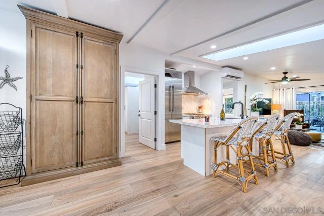 a kitchen with a refrigerator a oven and a sink