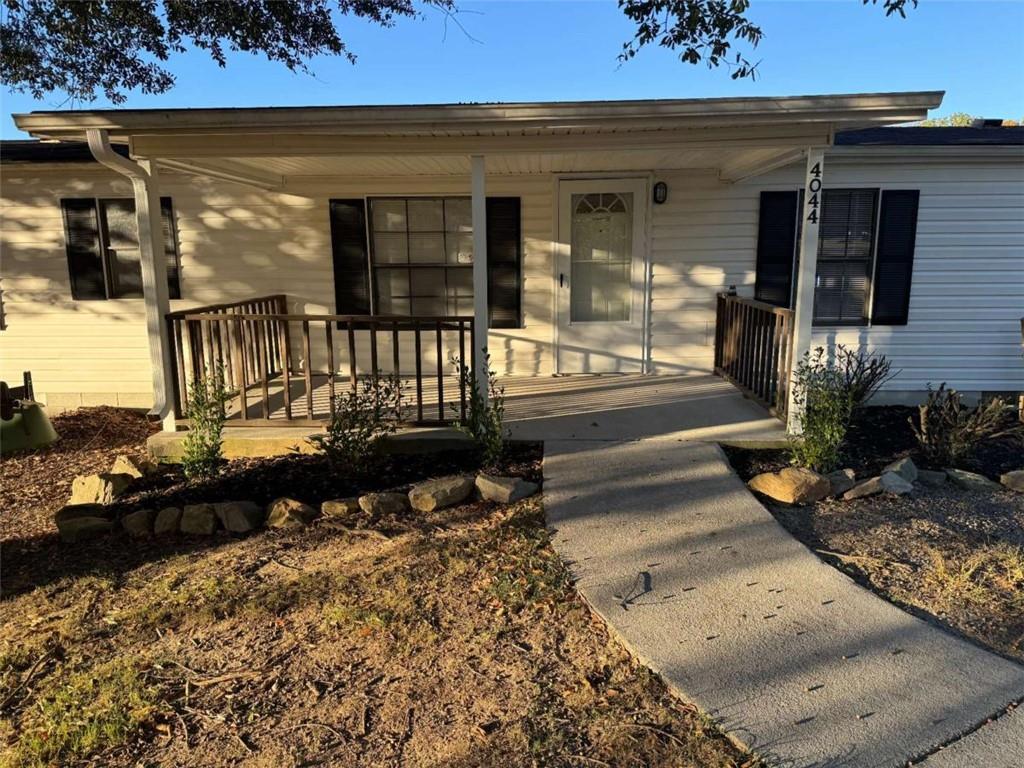 a view of a patio with table and chairs with wooden floor and fence