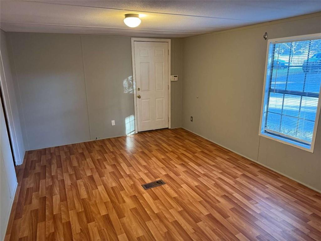4044 Friendship Road Buford, GA 30519 - Photo 13 of 30 a view of empty room with wooden floor and fan