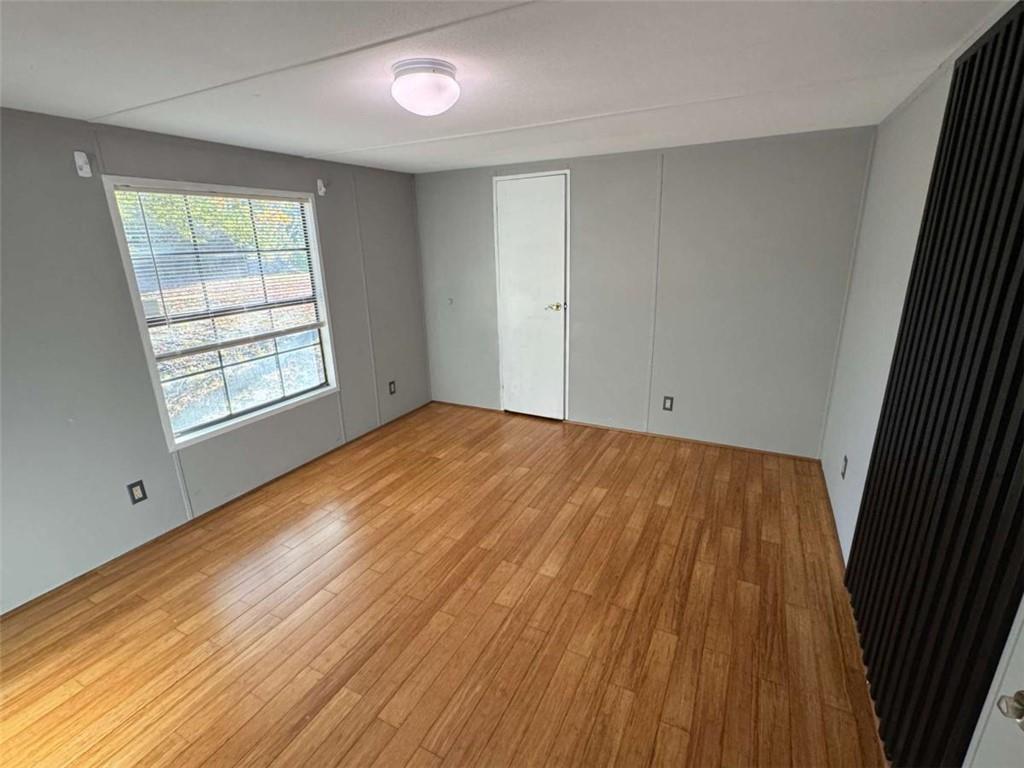 4044 Friendship Road Buford, GA 30519 - Photo 17 of 30 an empty room with wooden floor and windows