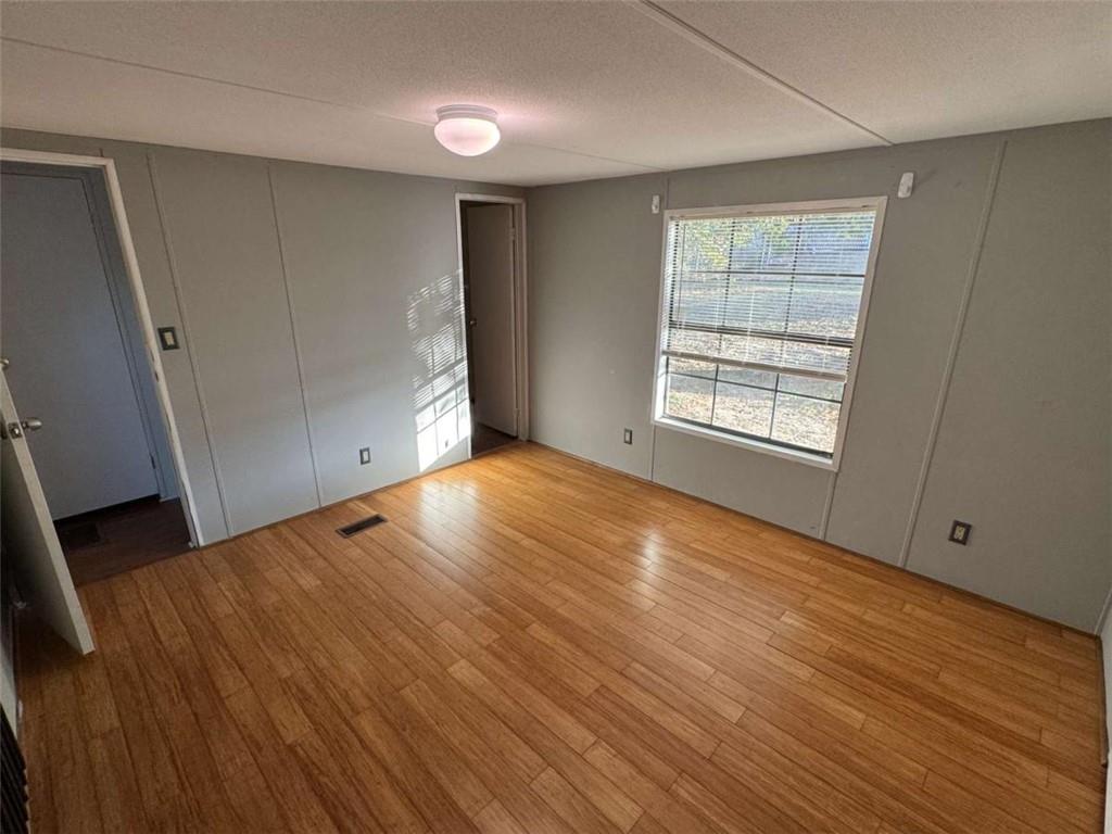 4044 Friendship Road Buford, GA 30519 - Photo 18 of 30 a view of an empty room with wooden floor and a window
