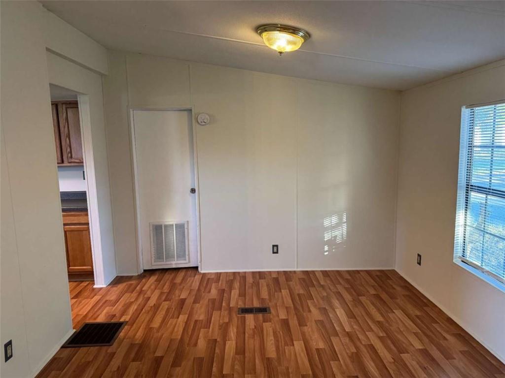 4044 Friendship Road Buford, GA 30519 - Photo 19 of 30 an empty room with wooden floor and windows