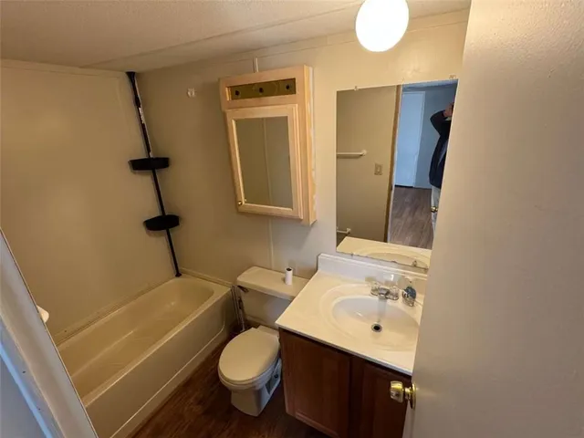 a bathroom with a sink toilet and mirror