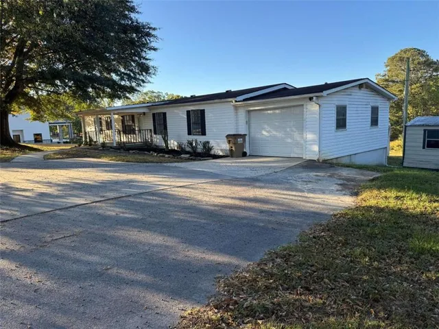 a view of a yard and front view of a house