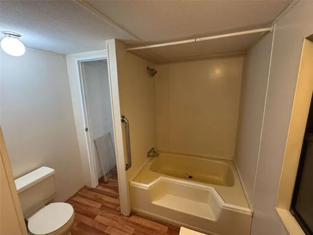 a bathroom with a tub and shower