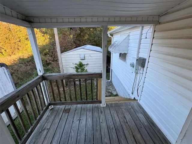 a view of deck with wooden floor and fence