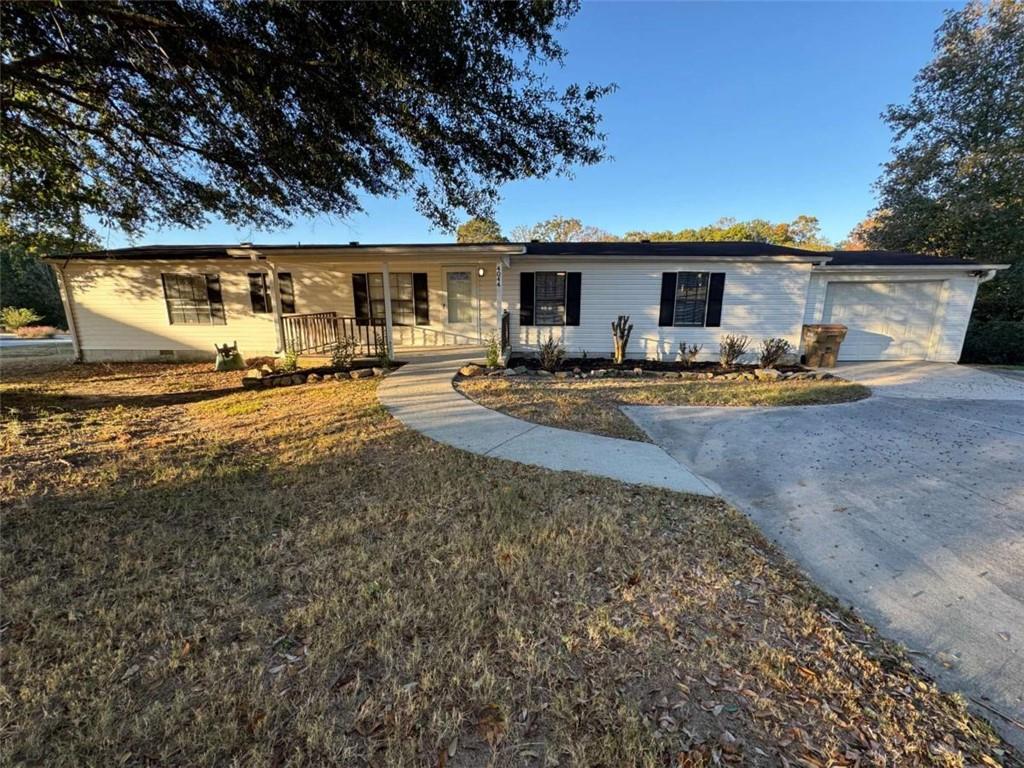 4044 Friendship Road Buford, GA 30519 - Photo 3 of 30 a view of a house with backyard space and a car parked in it
