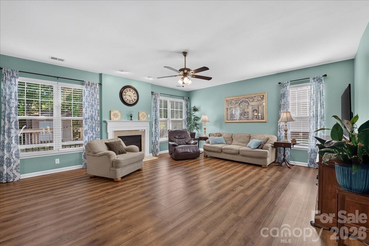 8006 Fine Robe Drive Indian Trail, NC 28079 - Photo 8 of 36 a living room with furniture a fireplace and a large window