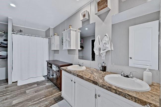 104 Private Road 1114 Decatur, TX 76234 - Photo 14 of 39 a bathroom with a granite countertop sink a mirror and shower