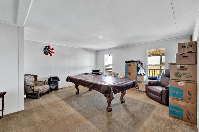 104 Private Road 1114 Decatur, TX 76234 - Photo 20 of 39 a living room with furniture a rug and a chandelier