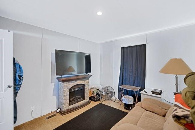 104 Private Road 1114 Decatur, TX 76234 - Photo 26 of 39 a living room with furniture a flat screen tv and a fireplace