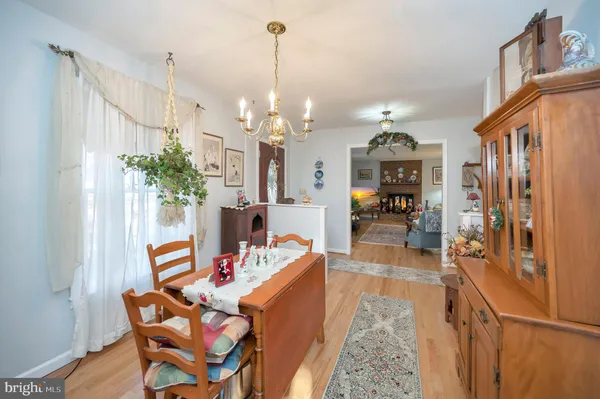 a dining room with furniture and a chandelier