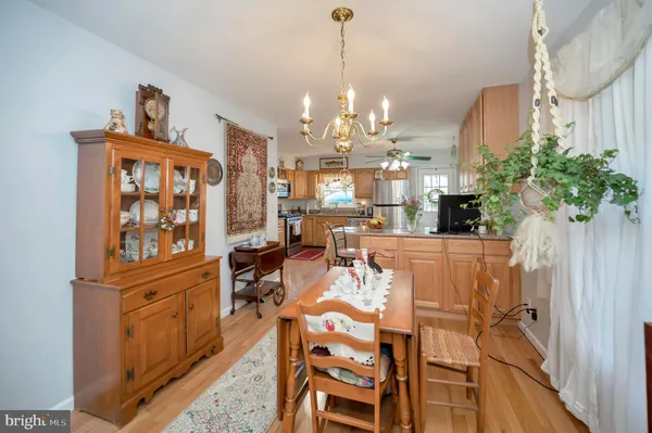 a view of a dining room with furniture a chandelier and wooden floor