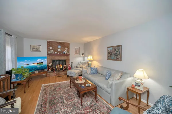 a living room with furniture a fireplace and a table
