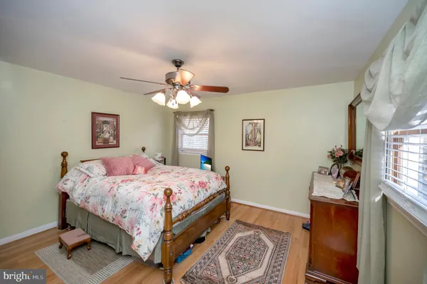 a bedroom with a bed chandelier and a window