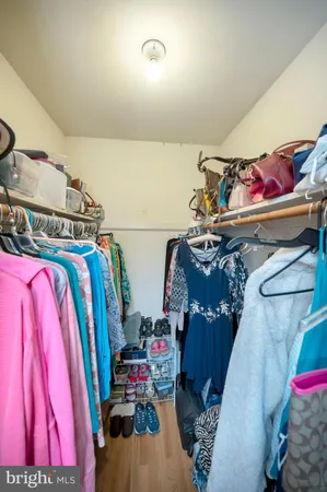 a view of walk in closet with clothes